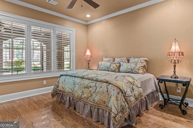 1031 Sugar Run, Greensboro, GA 30642 - bedroom featuring wood finished floors, ornamental molding, and a ceiling fan
