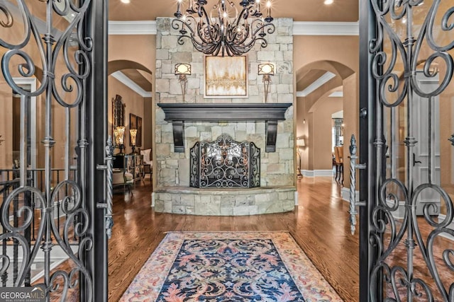 1031 Sugar Run, Greensboro, GA 30642 - entrance foyer featuring arched walkways, ornamental molding, a chandelier, and wood finished floors