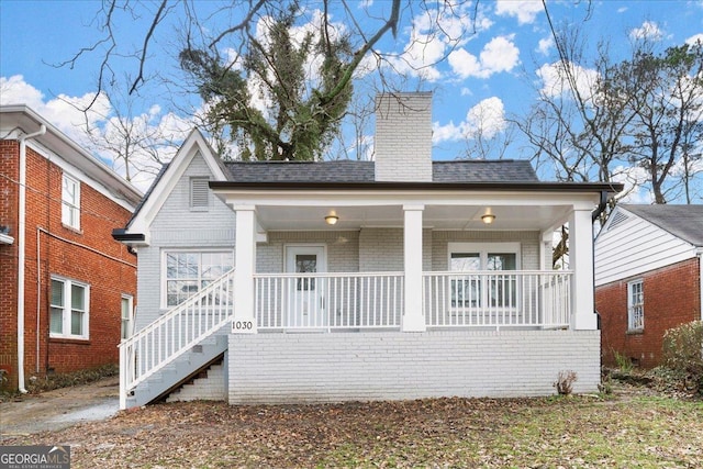 1030 Westmoor Dr NW, Atlanta, GA 30314 - view of front of house with brick siding, a porch, a chimney, and a shingled roof
