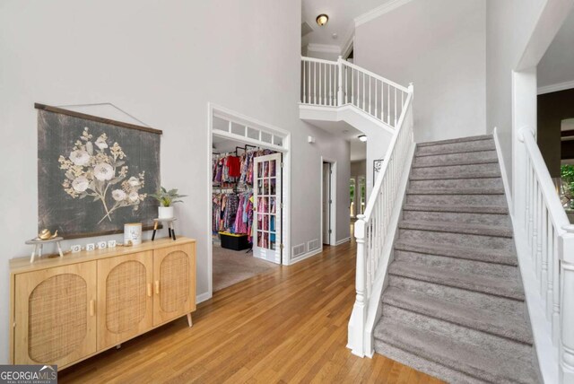 117 Willow View Ln, Canton, GA 30114 - stairway with wood finished floors, a high ceiling, and ornamental molding
