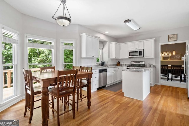 117 Willow View Ln, Canton, GA 30114 - kitchen with appliances with stainless steel finishes, a kitchen island, white cabinetry, light wood-style floors, and recessed lighting