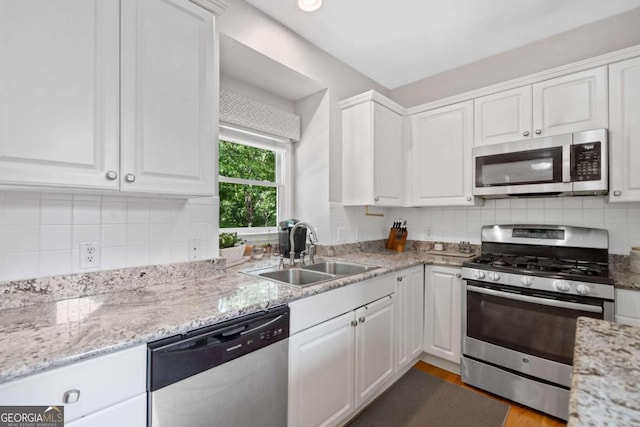 117 Willow View Ln, Canton, GA 30114 - kitchen featuring appliances with stainless steel finishes, white cabinets, backsplash, and light stone countertops