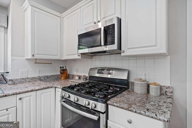 117 Willow View Ln, Canton, GA 30114 - kitchen with stainless steel appliances, white cabinetry, and decorative backsplash