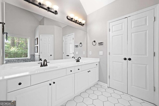 117 Willow View Ln, Canton, GA 30114 - full bathroom featuring lofted ceiling, double vanity, and tile patterned flooring