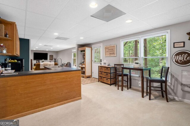 117 Willow View Ln, Canton, GA 30114 - kitchen featuring dark countertops, light colored carpet, open shelves, a paneled ceiling, and a peninsula