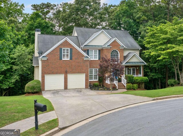 117 Willow View Ln, Canton, GA 30114 - traditional-style home featuring driveway, a chimney, brick siding, a front yard, and a garage