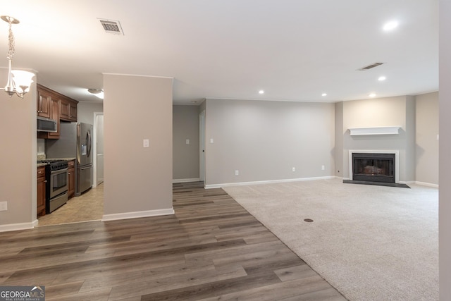 1017 Ridgefield Dr, Peachtree City, GA 30269 - unfurnished living room with recessed lighting, light wood finished floors, a fireplace with flush hearth, and baseboards