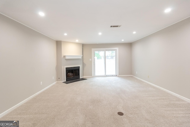 1017 Ridgefield Dr, Peachtree City, GA 30269 - unfurnished living room featuring recessed lighting, a fireplace with flush hearth, light carpet, and baseboards