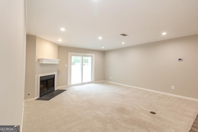 1017 Ridgefield Dr, Peachtree City, GA 30269 - unfurnished living room featuring a fireplace with flush hearth, recessed lighting, baseboards, and carpet