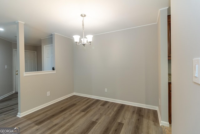 1017 Ridgefield Dr, Peachtree City, GA 30269 - spare room with wood finished floors, a chandelier, and baseboards