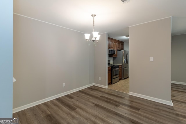 1017 Ridgefield Dr, Peachtree City, GA 30269 - unfurnished dining area featuring a chandelier, wood finished floors, and baseboards