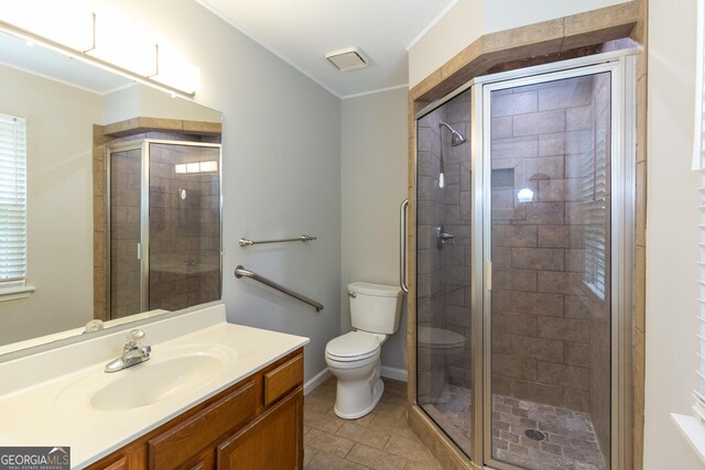 1017 Ridgefield Dr, Peachtree City, GA 30269 - bathroom with toilet, vanity, a shower stall, tile patterned floors, and ornamental molding