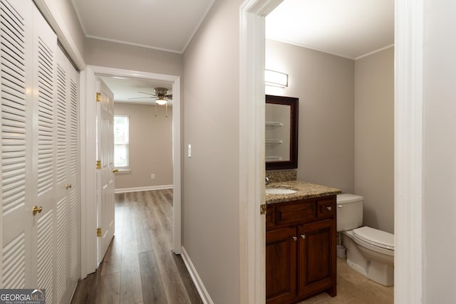 1017 Ridgefield Dr, Peachtree City, GA 30269 - hall with a sink, wood finished floors, baseboards, and ornamental molding