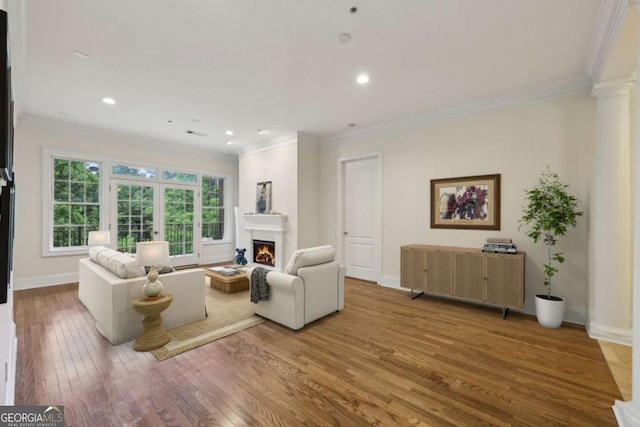 3280 Stillhouse Ln SE Unit 212, Atlanta, GA 30339 - living room with ornamental molding, hardwood / wood-style flooring, a lit fireplace, recessed lighting, and decorative columns