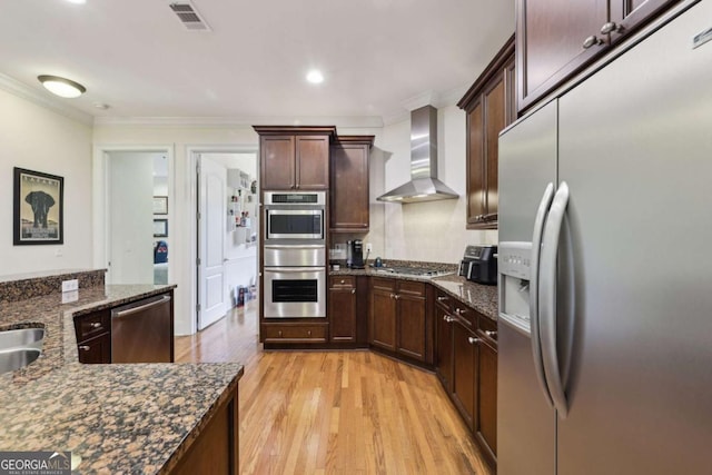 3280 Stillhouse Ln SE Unit 212, Atlanta, GA 30339 - kitchen with appliances with stainless steel finishes, wall chimney exhaust hood, a warming drawer, light wood finished floors, and crown molding