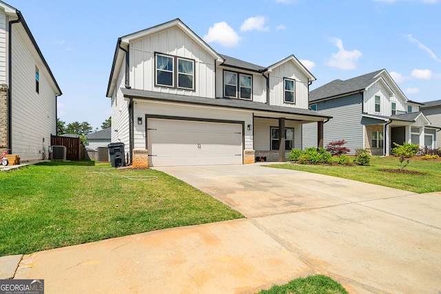 4720 Dufour Dr, Lilburn, GA 30047 - view of front of property featuring board and batten siding, a garage, driveway, and a front lawn