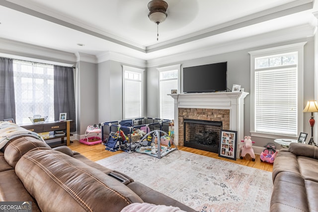 23 Raleigh Dr, Lafayette, GA 30728 - living area featuring a stone fireplace, wood finished floors, a ceiling fan, healthy amount of natural light, and crown molding