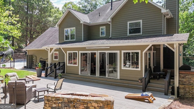 4320 Oklahoma Way NW, Kennesaw, GA 30152 - rear view of property featuring a fire pit, a wooden deck, roof with shingles, and a chimney