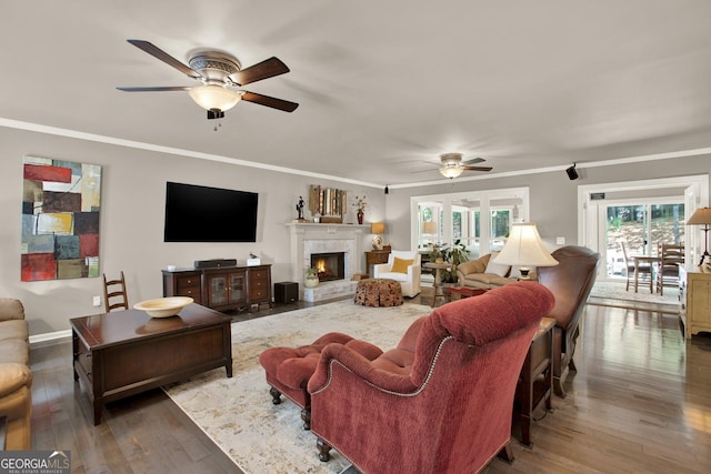 4320 Oklahoma Way NW, Kennesaw, GA 30152 - living room featuring ceiling fan, wood finished floors, a lit fireplace, ornamental molding, and baseboards