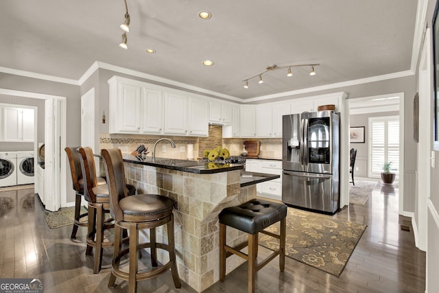 4320 Oklahoma Way NW, Kennesaw, GA 30152 - kitchen with stainless steel fridge, separate washer and dryer, dark countertops, white cabinetry, and a peninsula