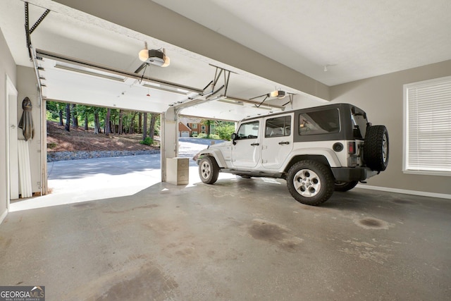 4320 Oklahoma Way NW, Kennesaw, GA 30152 - garage with a garage door opener and baseboards