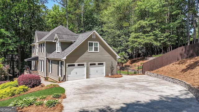 4320 Oklahoma Way NW, Kennesaw, GA 30152 - view of property exterior featuring driveway, roof with shingles, and a garage