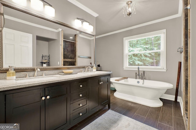 4320 Oklahoma Way NW, Kennesaw, GA 30152 - bathroom with ornamental molding, double vanity, a soaking tub, baseboards, and wood finish floors