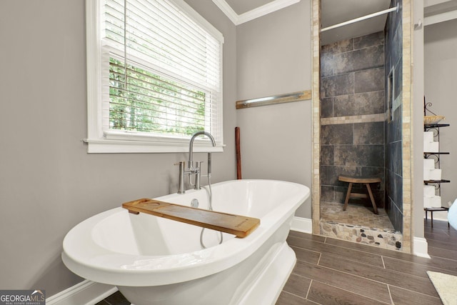 4320 Oklahoma Way NW, Kennesaw, GA 30152 - full bathroom with ornamental molding, wood finish floors, baseboards, a freestanding bath, and tiled shower