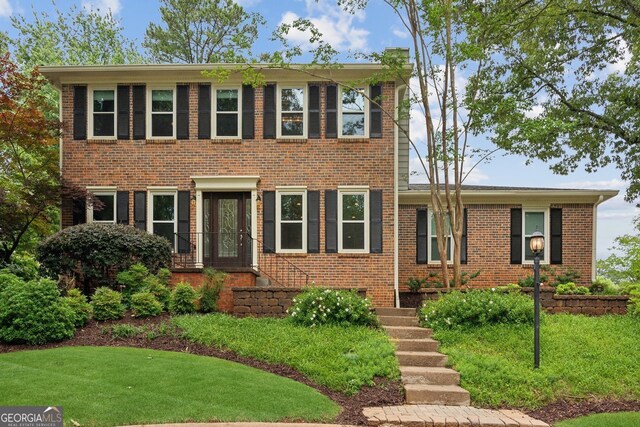 9800 Woodfall Dr, Roswell, GA 30076 - colonial-style house with brick siding and a front yard