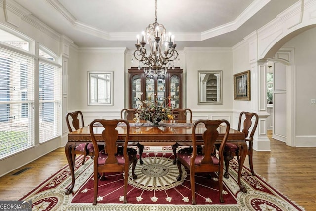 8970 Moor Park Run, Duluth, GA 30097 - dining room with arched walkways, a tray ceiling, healthy amount of natural light, crown molding, and a decorative wall