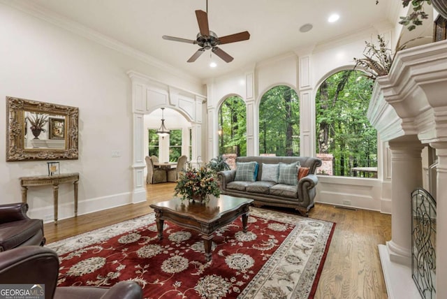 8970 Moor Park Run, Duluth, GA 30097 - living area with plenty of natural light, a ceiling fan, wood finished floors, crown molding, and recessed lighting