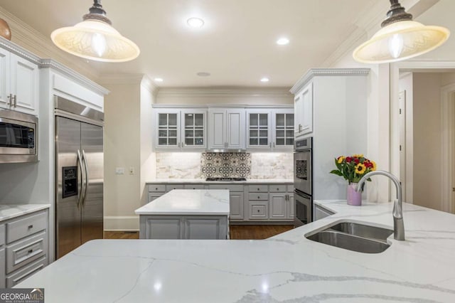 8970 Moor Park Run, Duluth, GA 30097 - kitchen featuring built in appliances, gray cabinets, dark wood-style floors, decorative backsplash, and crown molding
