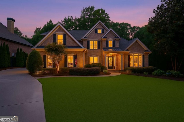 8970 Moor Park Run, Duluth, GA 30097 - colonial house featuring brick siding, a front lawn, and a standing seam roof