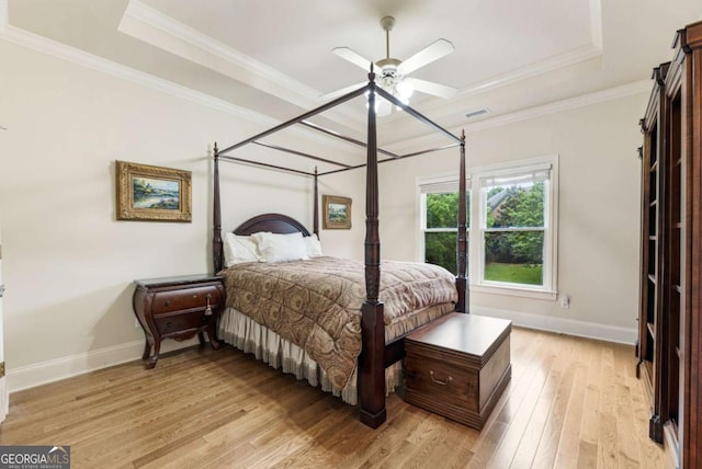 8970 Moor Park Run, Duluth, GA 30097 - bedroom featuring a raised ceiling, light wood-style floors, ornamental molding, and a ceiling fan