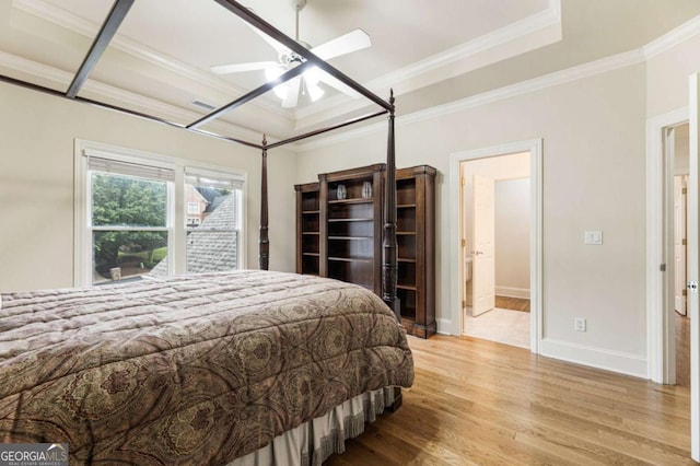 8970 Moor Park Run, Duluth, GA 30097 - bedroom featuring wood finished floors, crown molding, a tray ceiling, and a ceiling fan