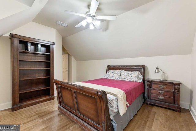 8970 Moor Park Run, Duluth, GA 30097 - bedroom with light wood-type flooring, lofted ceiling, and ceiling fan