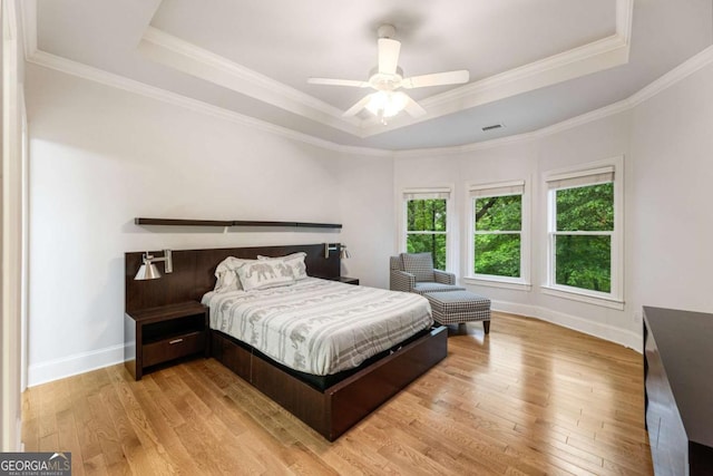 8970 Moor Park Run, Duluth, GA 30097 - bedroom featuring a raised ceiling, light wood-style flooring, ornamental molding, and a ceiling fan