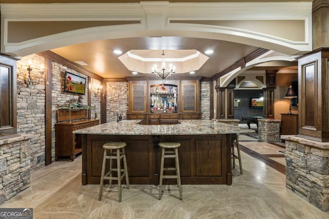 8970 Moor Park Run, Duluth, GA 30097 - bar featuring arched walkways, crown molding, light marble finish floors, ornate columns, and a chandelier