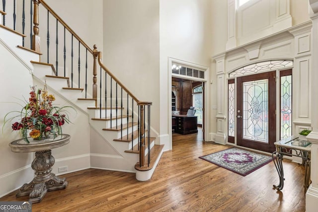 8970 Moor Park Run, Duluth, GA 30097 - entrance foyer featuring wood finished floors, a high ceiling, and stairway