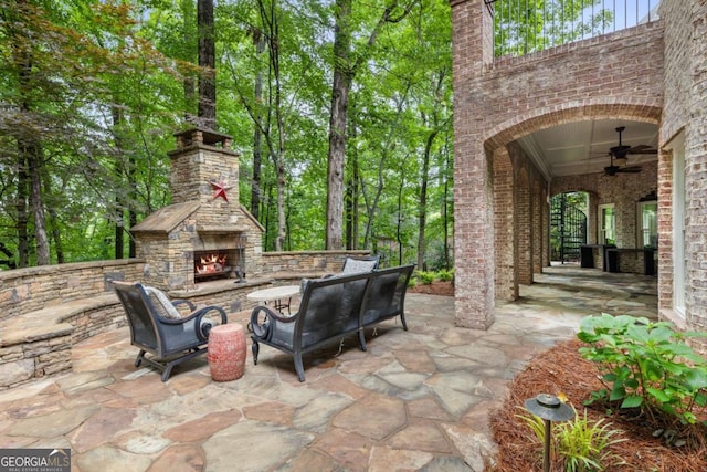 8970 Moor Park Run, Duluth, GA 30097 - view of patio / terrace with a ceiling fan and an outdoor living space with a fireplace