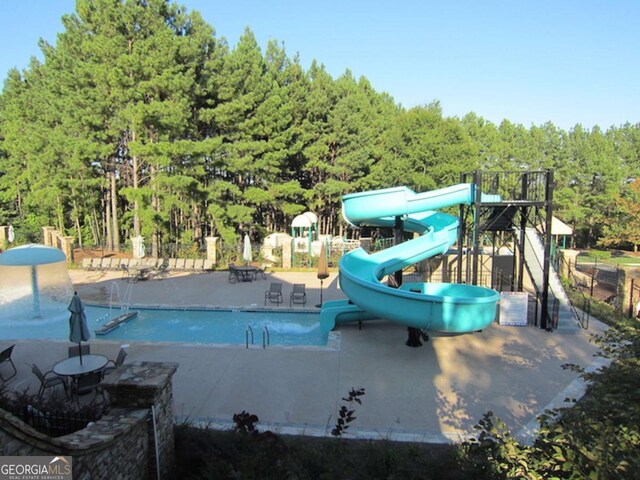 8970 Moor Park Run, Duluth, GA 30097 - community pool with a water slide, a forest view, and a patio area