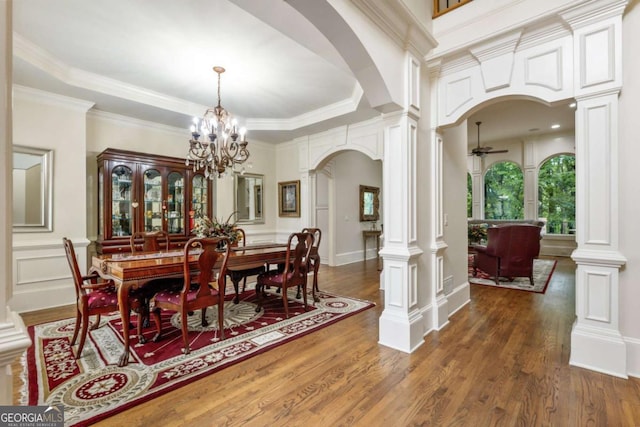 8970 Moor Park Run, Duluth, GA 30097 - dining space featuring arched walkways, decorative columns, wood finished floors, a ceiling fan, and a decorative wall