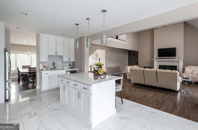 1270 Mccannon Morris Rd, Hull, GA 30646 - kitchen featuring appliances with stainless steel finishes, a sink, open floor plan, light marble finish flooring, and light countertops