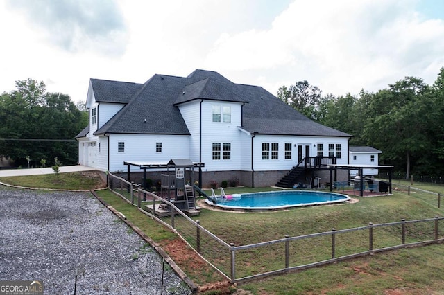 1270 Mccannon Morris Rd, Hull, GA 30646 - rear view of house featuring stairway, gravel driveway, roof with shingles, a wooden deck, and a playground