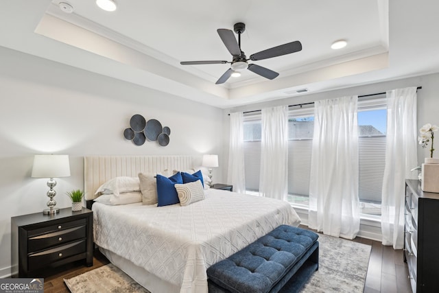 1174 City Park Ln, Decatur, GA 30033 - bedroom featuring a tray ceiling, multiple windows, dark wood-style flooring, crown molding, and a ceiling fan