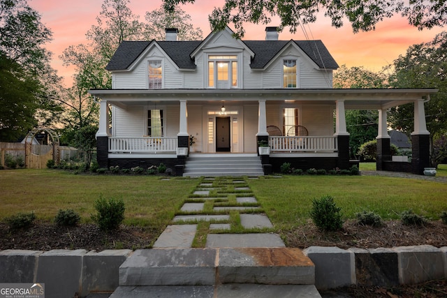15 Robinson St, Newnan, GA 30263 - view of front of home featuring covered porch, a front yard, and a chimney