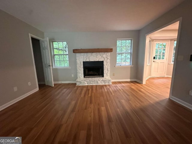 80 Brooks Ln, Dallas, GA 30157 - unfurnished living room featuring wood finished floors and a stone fireplace