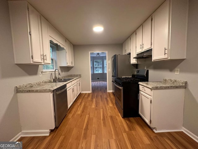 80 Brooks Ln, Dallas, GA 30157 - kitchen with appliances with stainless steel finishes, under cabinet range hood, white cabinets, and light wood-type flooring