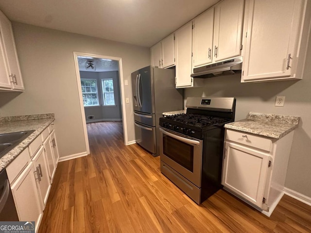 80 Brooks Ln, Dallas, GA 30157 - kitchen featuring under cabinet range hood, stainless steel appliances, light wood-style floors, and white cabinets