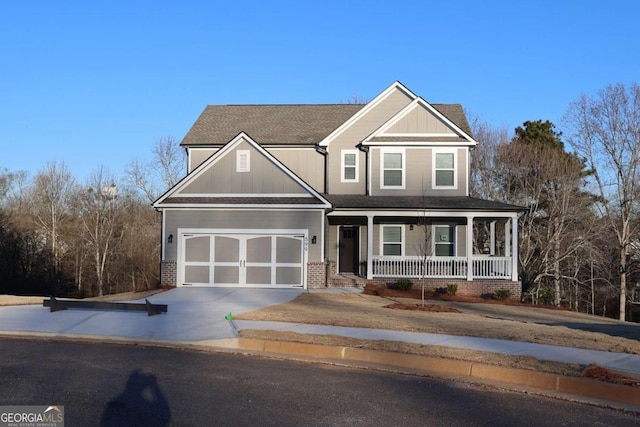 599 Calgary Downs Dr, Winder, GA 30680 - craftsman-style home with a porch, driveway, board and batten siding, and a shingled roof